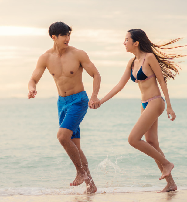 happy couple running on beach