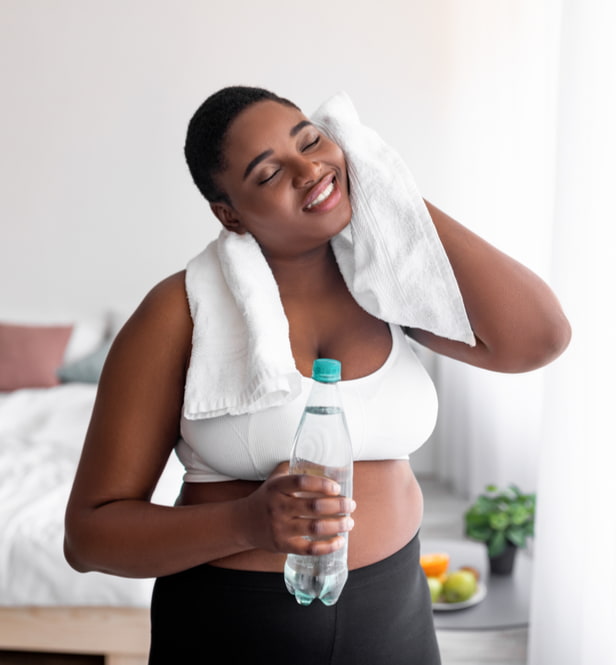 woman toweling herself off after exercise