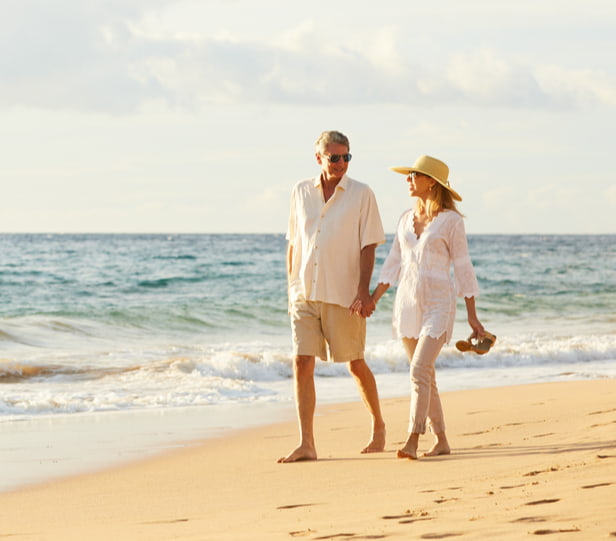 mature couple walking on the beach holding hands