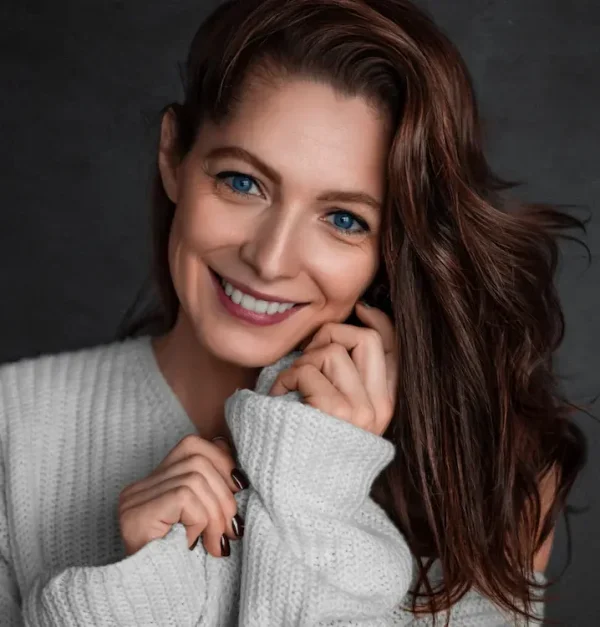 woman in her 40s smiling after non-surgical eye lift